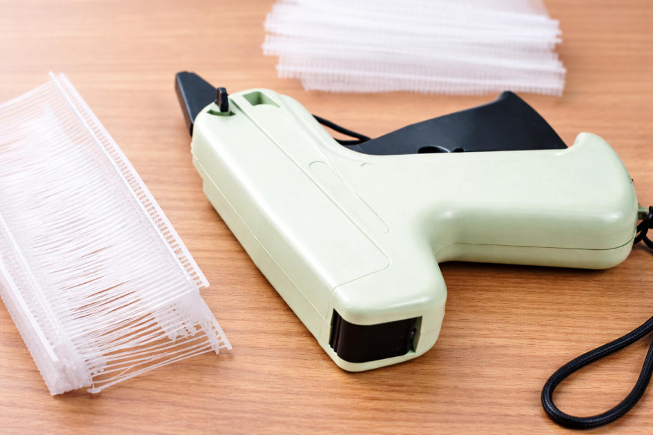 A tagging gun with different fastener lengths displayed side by side